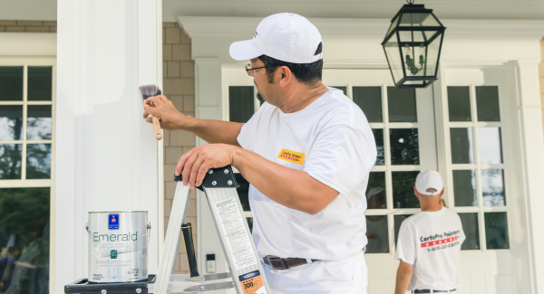 Contractor painting an exterior column